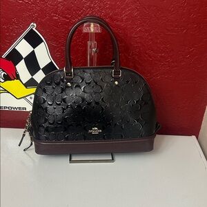 Coach Black and Brown Embossed Satchel comes with unbranded strap that matches.